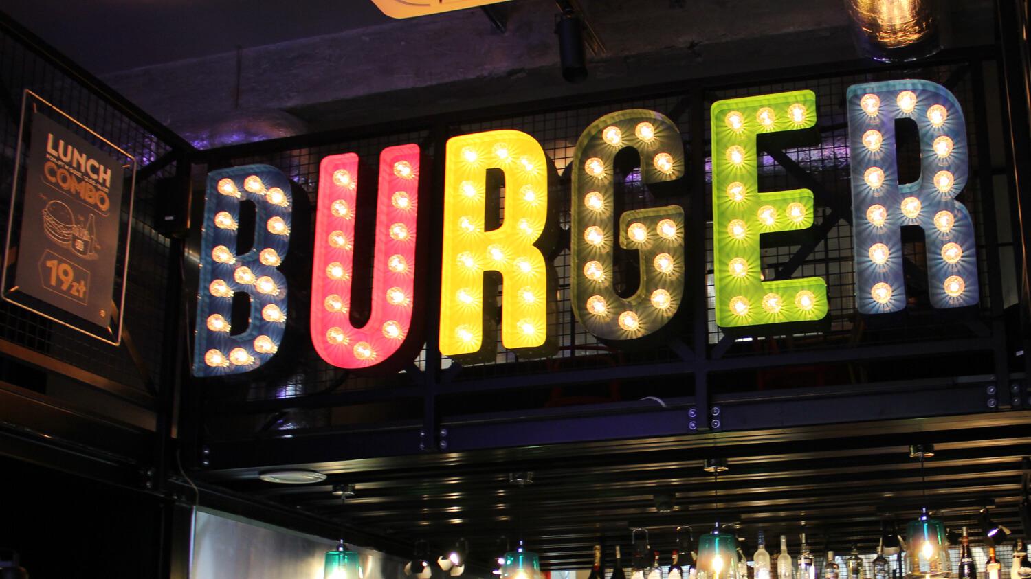 Burger - colored letters with bulbs placed above the entrance