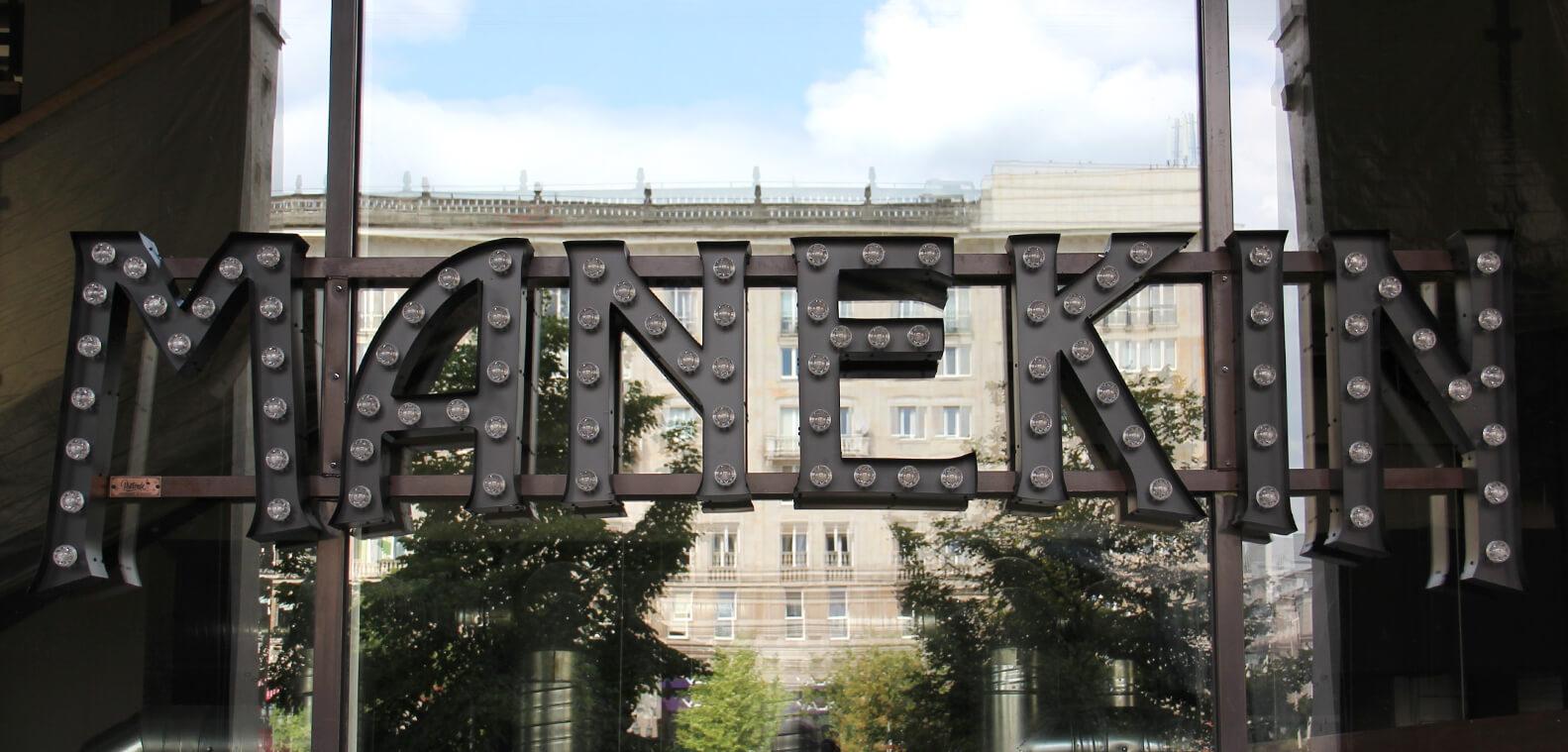 Mannequin - letters with bulbs placed on the rack above the entrance