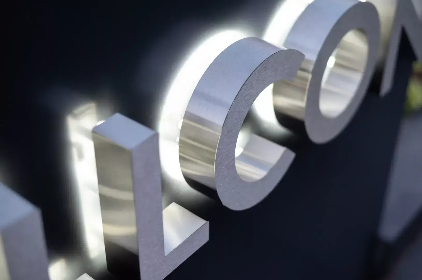 Allcon back-lit letters - Silver polished letters shining backwards on the wall Allcon