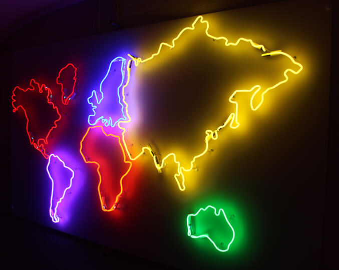 Map of the world created as a neon sign, placed on the wall inside the premises