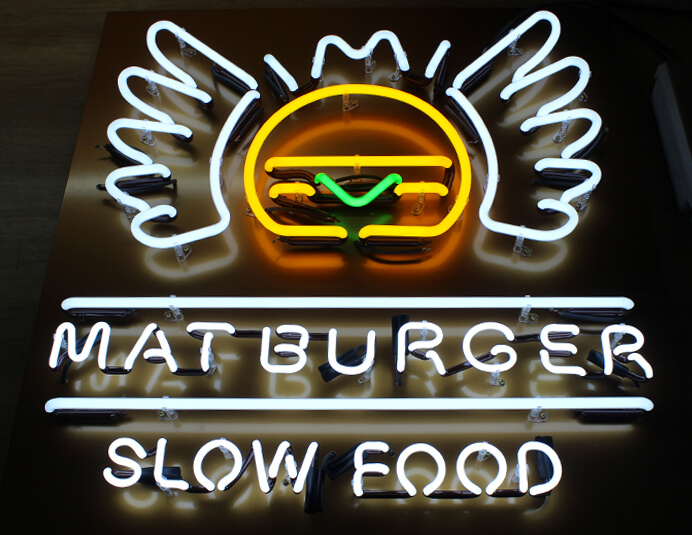 Mat Burger - neon sign advertising symbols placed next to the entrance