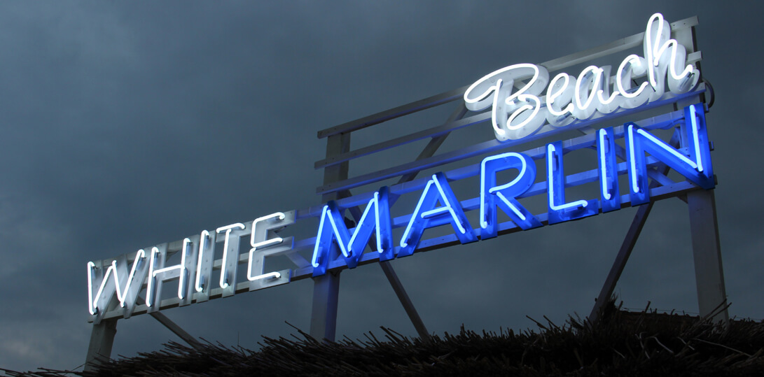 White Marlin - advertising neon sign placed on a frame, on the roof of the building