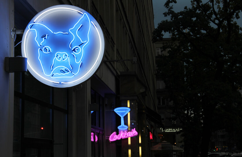 Bulldog - neon sign with company logo placed on advertising semaphore