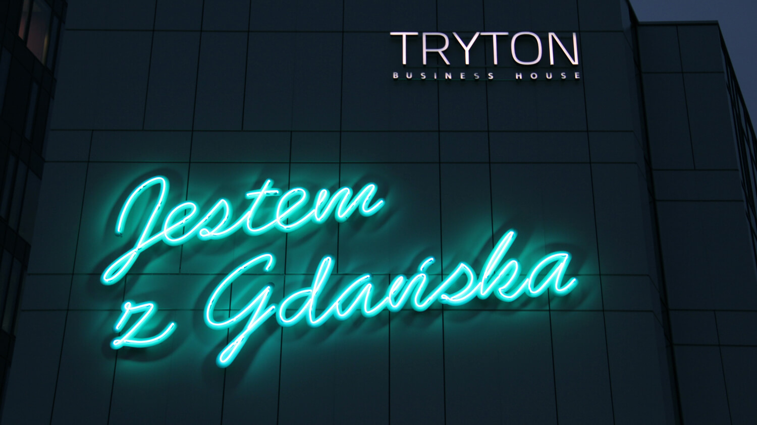 Triton - opschrift "Ik kom uit Gdansk" gemaakt van neonreclames, geplaatst op de gevel