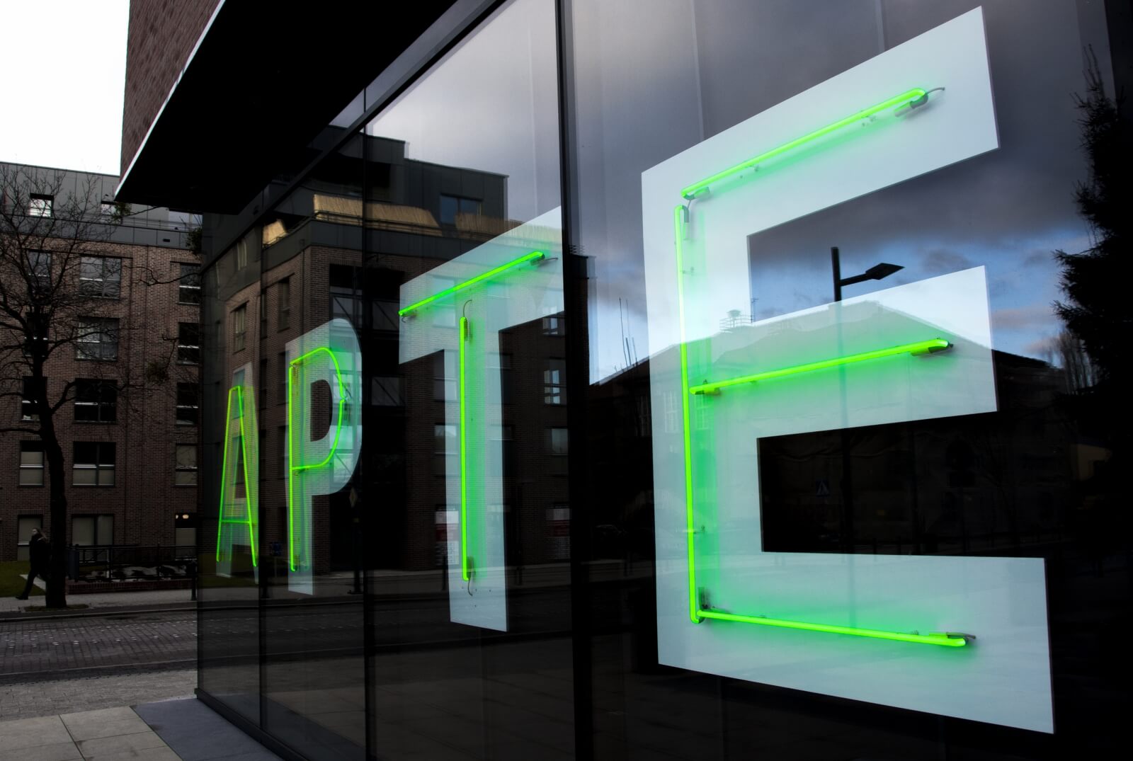 Pharmacy - advertising neon sign, mounted on a plexiglass panel, placed behind the glass window