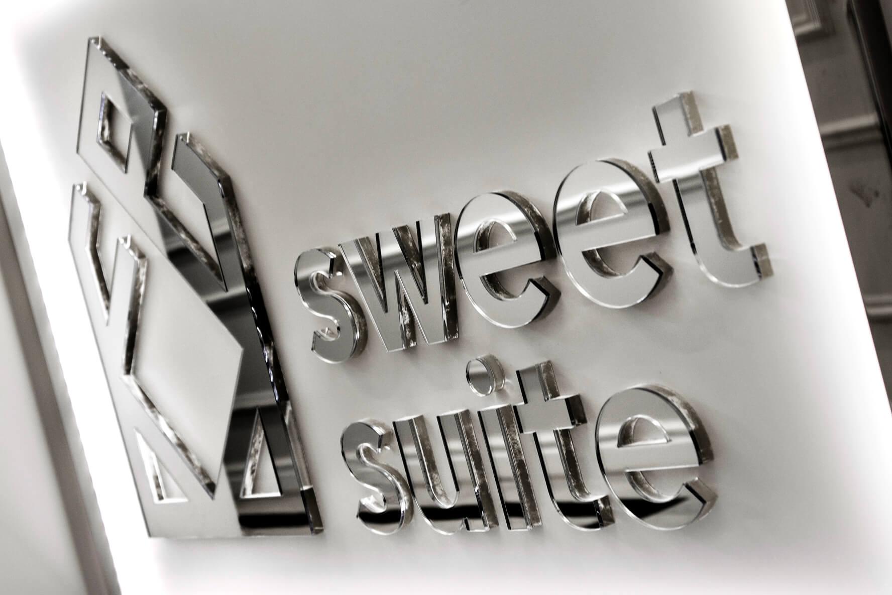 Sweet suit - company logo and 3D space letters made of Plexiglas with mirror effect