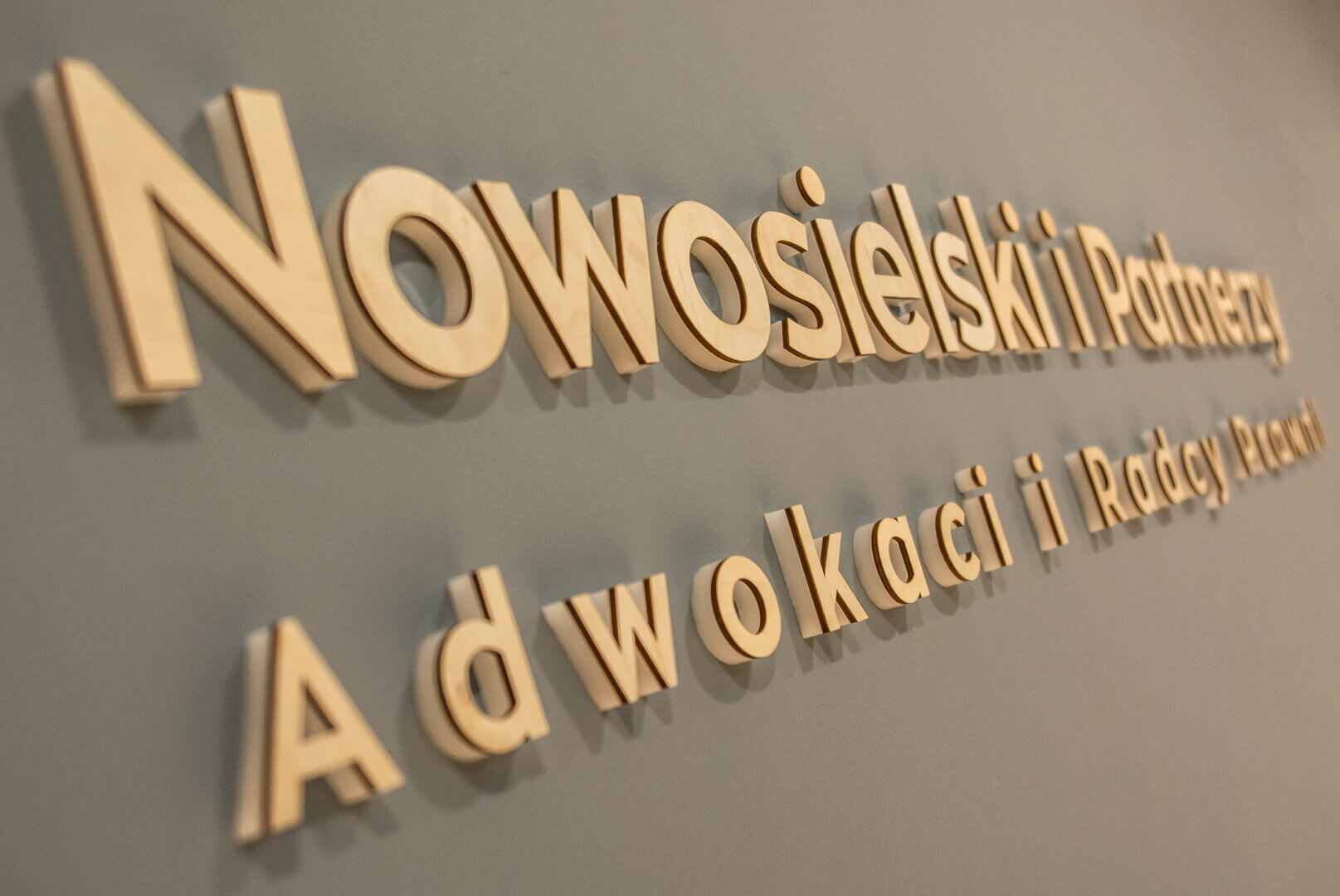 Nowosielski and Partners - spatial letters made of plywood placed in the lobby