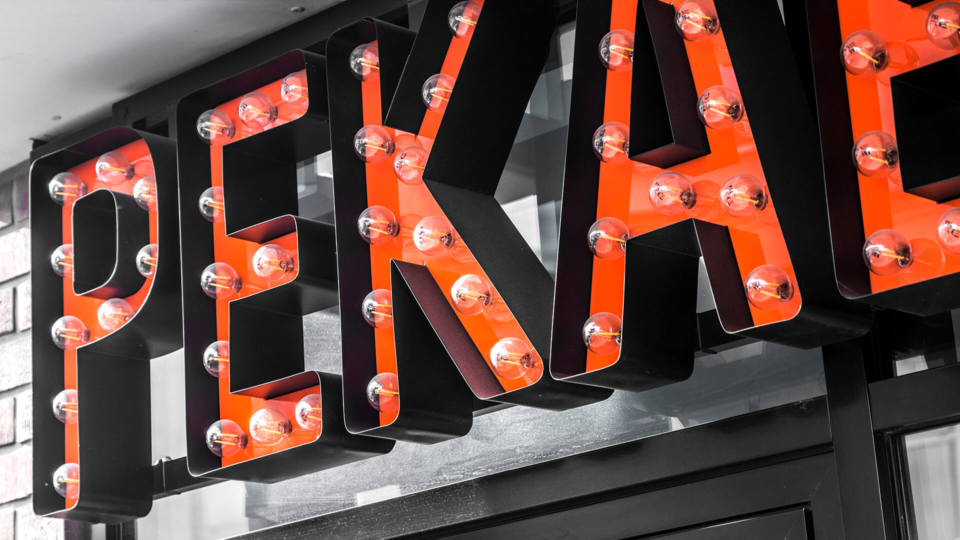 pekaesy-letters-with-lights-over-the-entry-to-barbera-letters-with-coloured-on-height-mounted-to-the-panel-on-the-window-with-company-logo-letters-spatial-3d-poznan