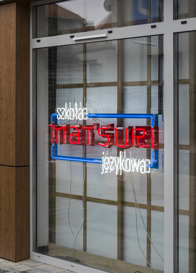 matsuri-school-linguïstisch-neon-op-plexi-hangt-achter-het-glas-neon-bij-de-entree-neon-kleur-logo-firma-neon-laag-neon-op-tentoonstelling-neon-in-kantoor-rood-glas-gdansk-przymorze