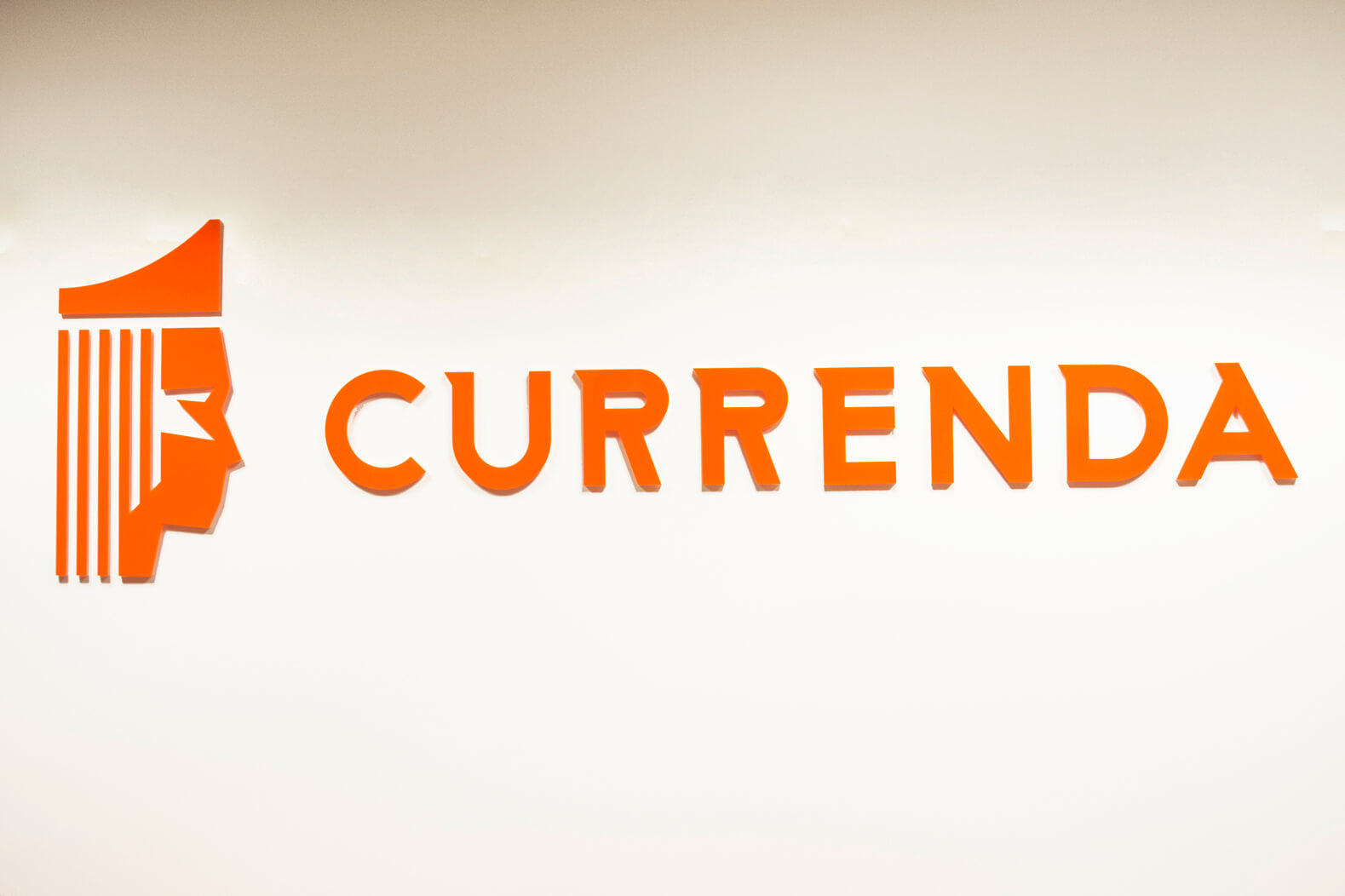 Currenda - logo and 3D space letters placed on the wall