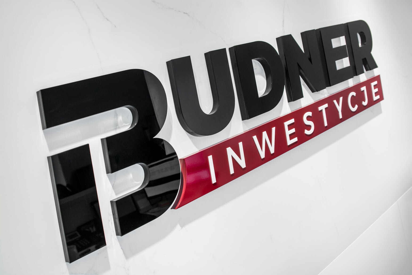 Budner Investments - logo and 3D space letters placed on the wall