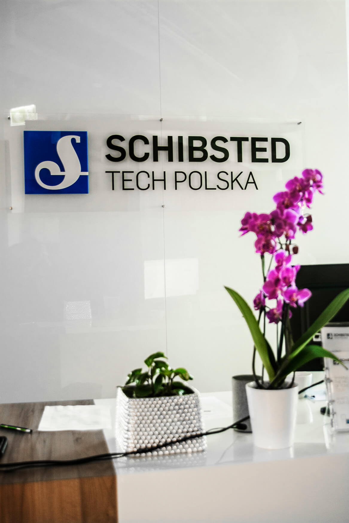 Schibsted Tech Polska - 3D-Logo und räumliche Buchstaben auf Plexiglassockel im Empfangsbereich