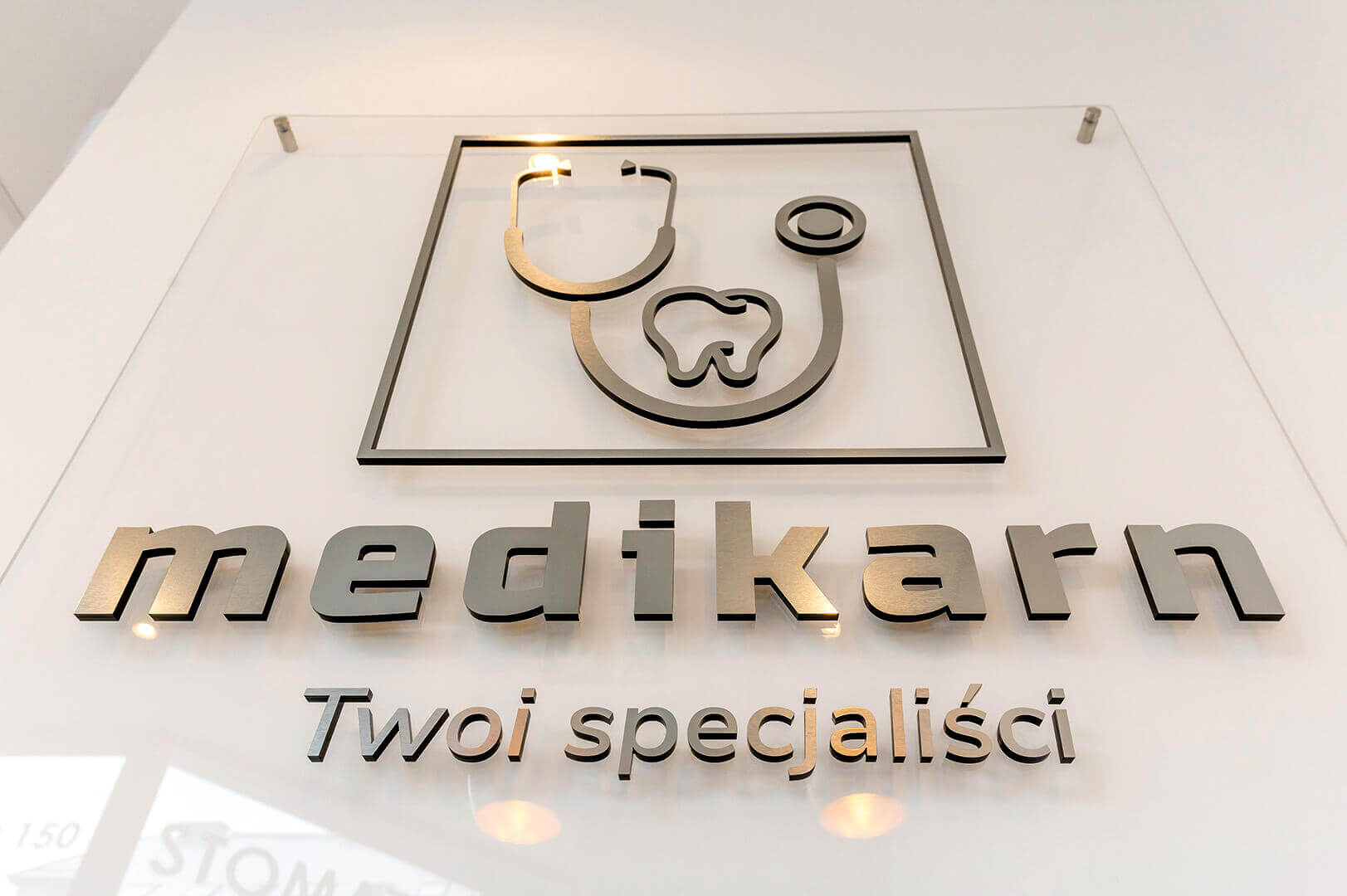 Medikarn;letters_space_sign_with_logo_and_company_name_made_from_solid_steel_and_glass_base