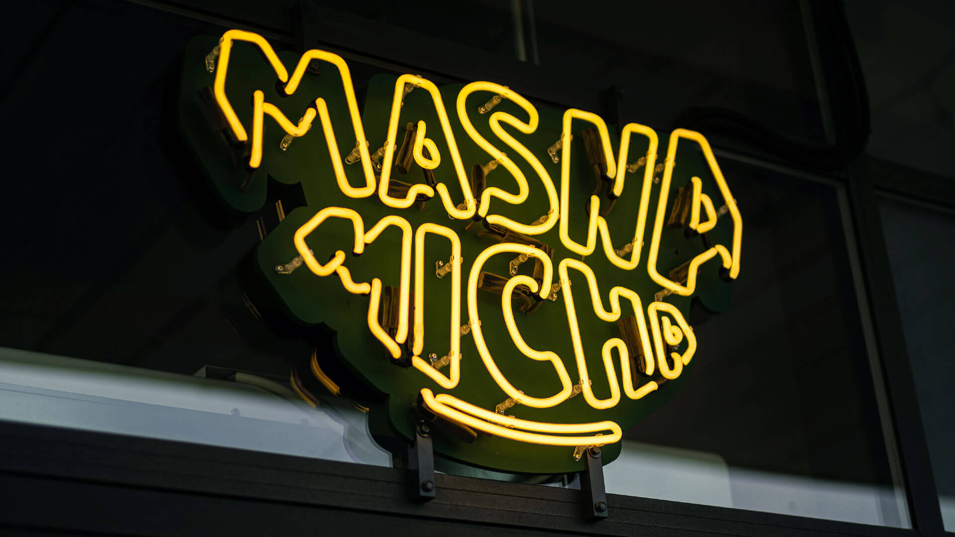 Neon sign for Masna Micha restaurant in Gdansk, outside the premises.