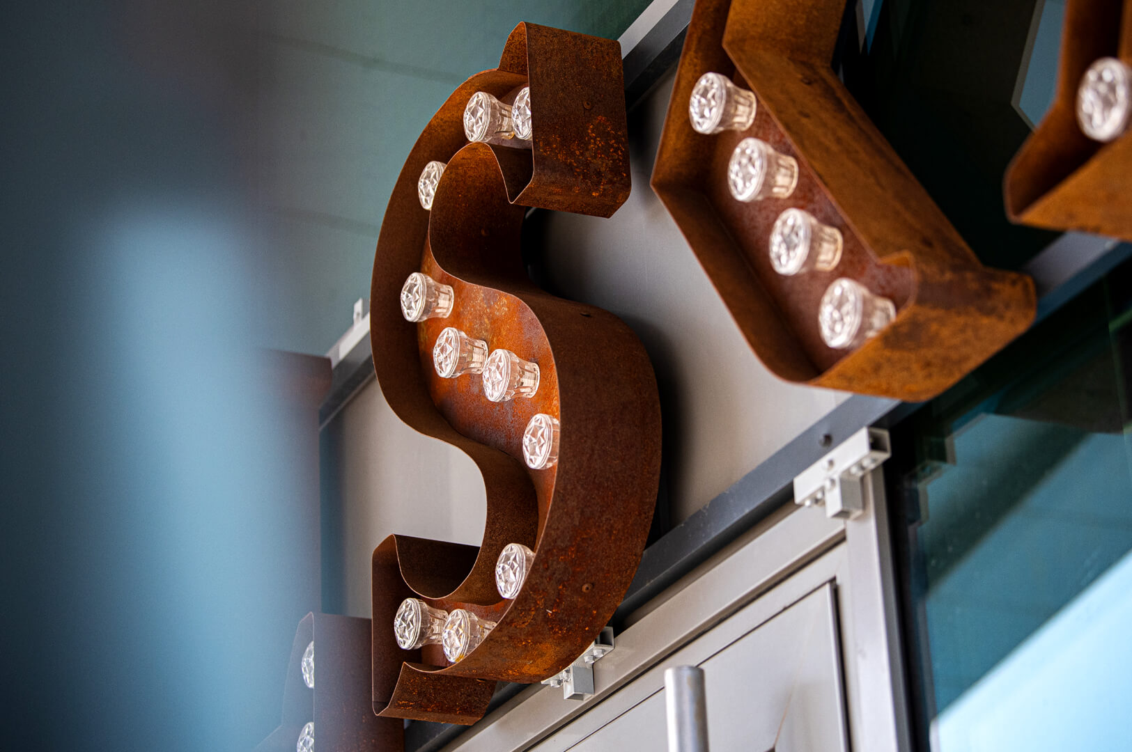 Rusted letters with retro light bulbs Kalska