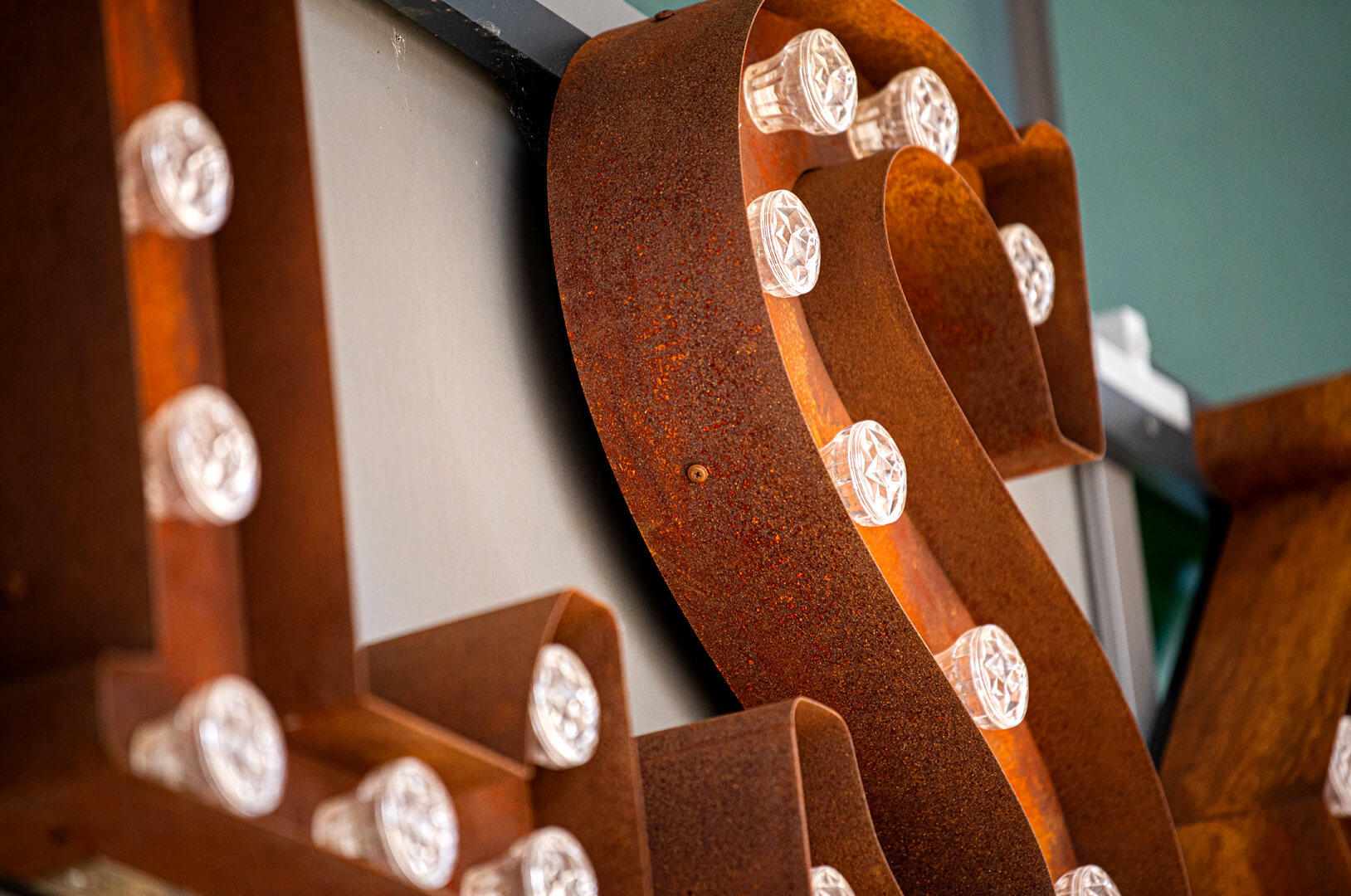 Rusted letters with retro light bulbs Kalska