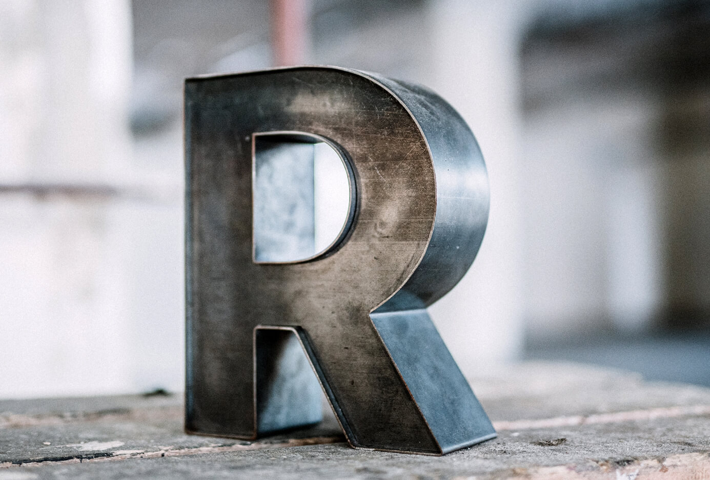 Letters R made of steel sheet in industrial style.