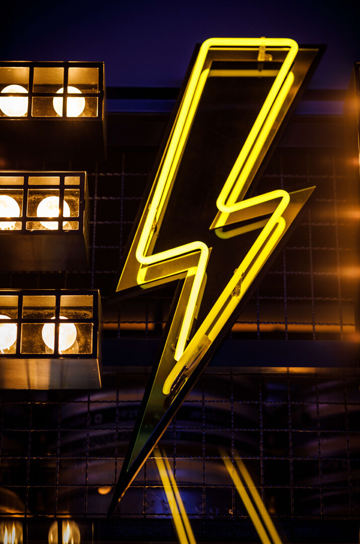 Letters with bulbs along with neon symbol in yellow color