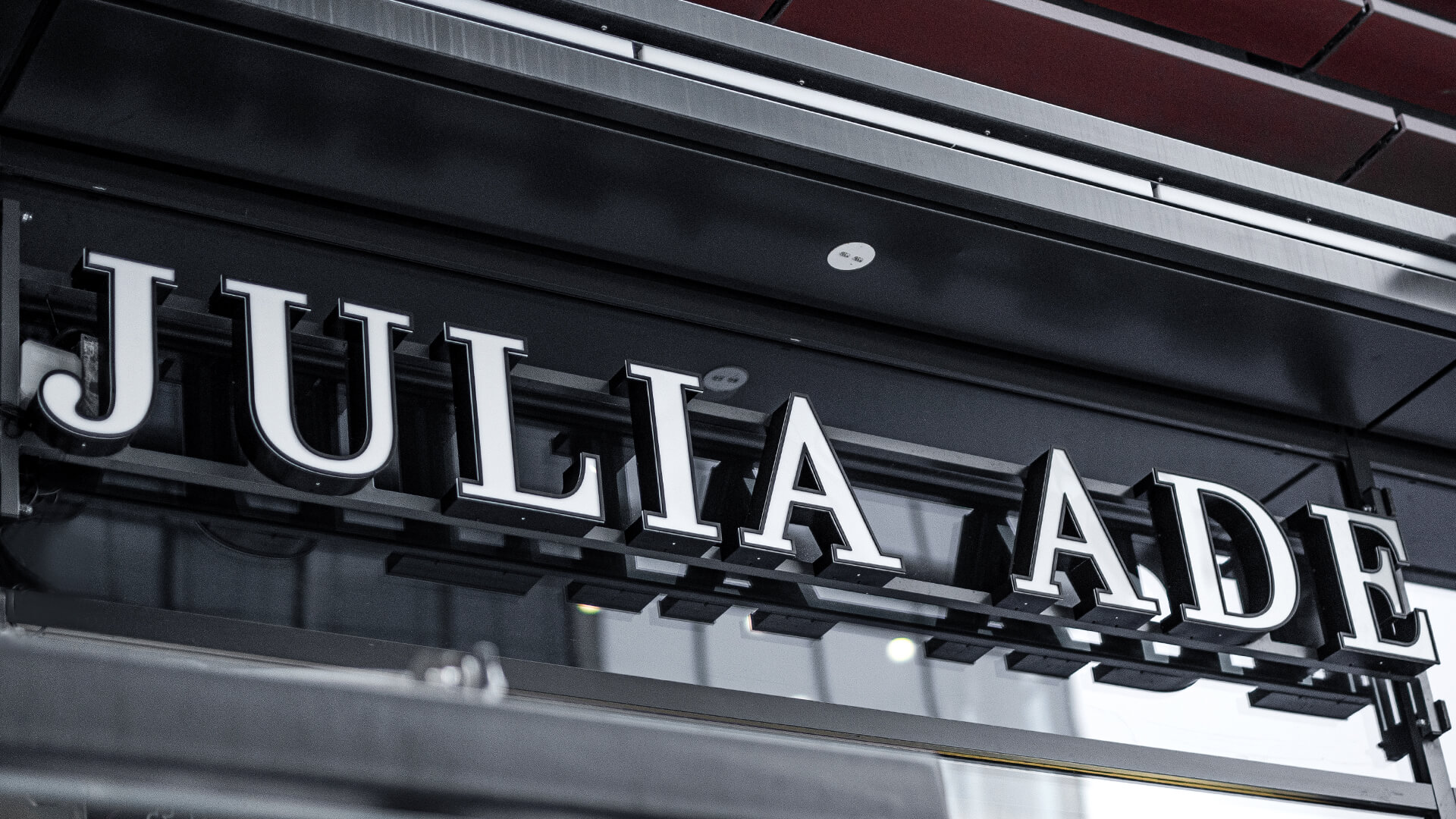 Letters over the entrance, spatial, shining front in white