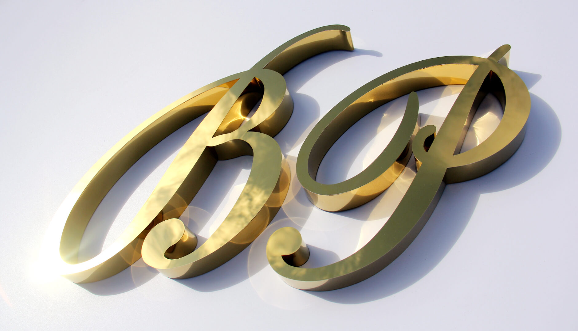 Gold letters B and P, artistic, unique. Made of stainless steel.