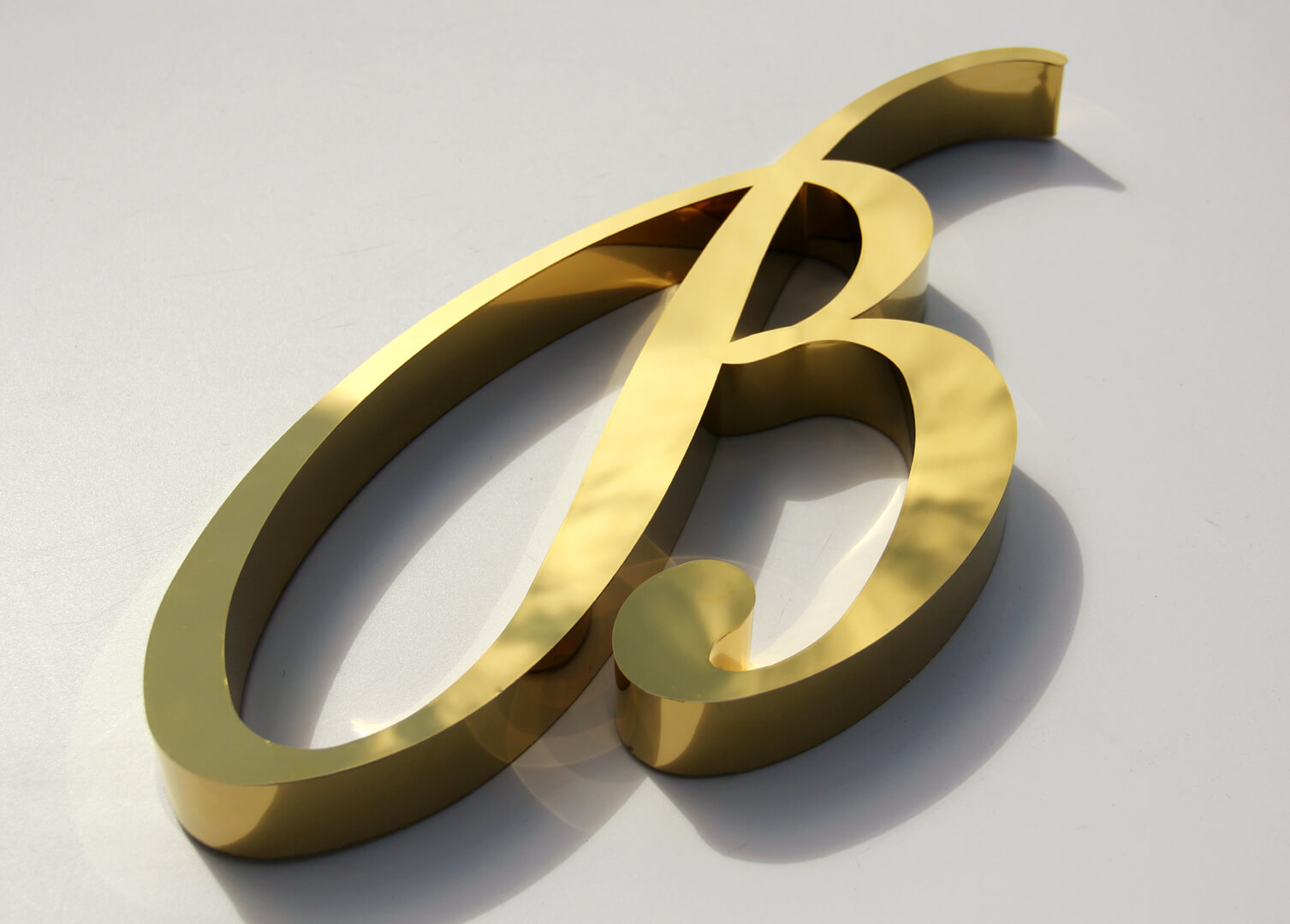 Gold letter B in stainless steel.