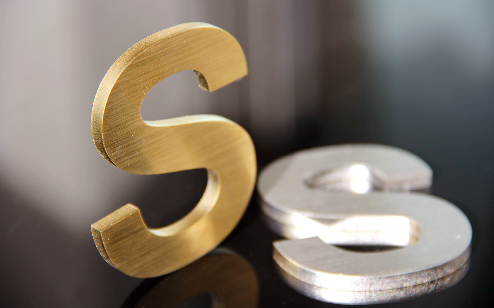 Gold and silver letter S, made of metal