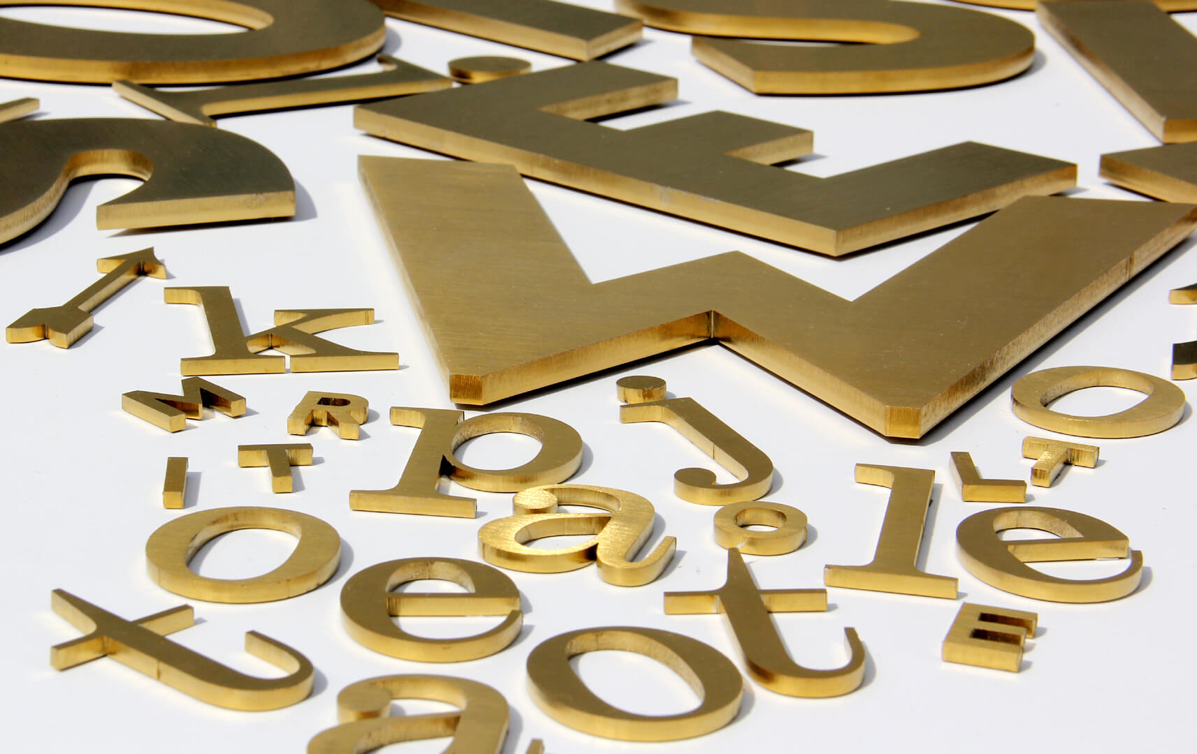 Metal letters in gold color, industrial style.