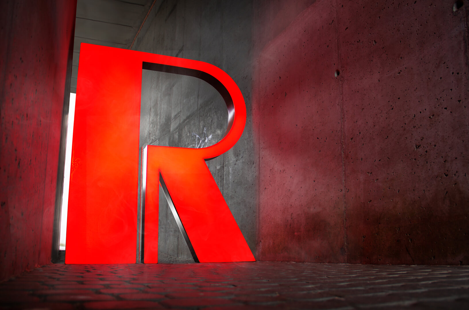 Large format letter R in red, LED backlit.