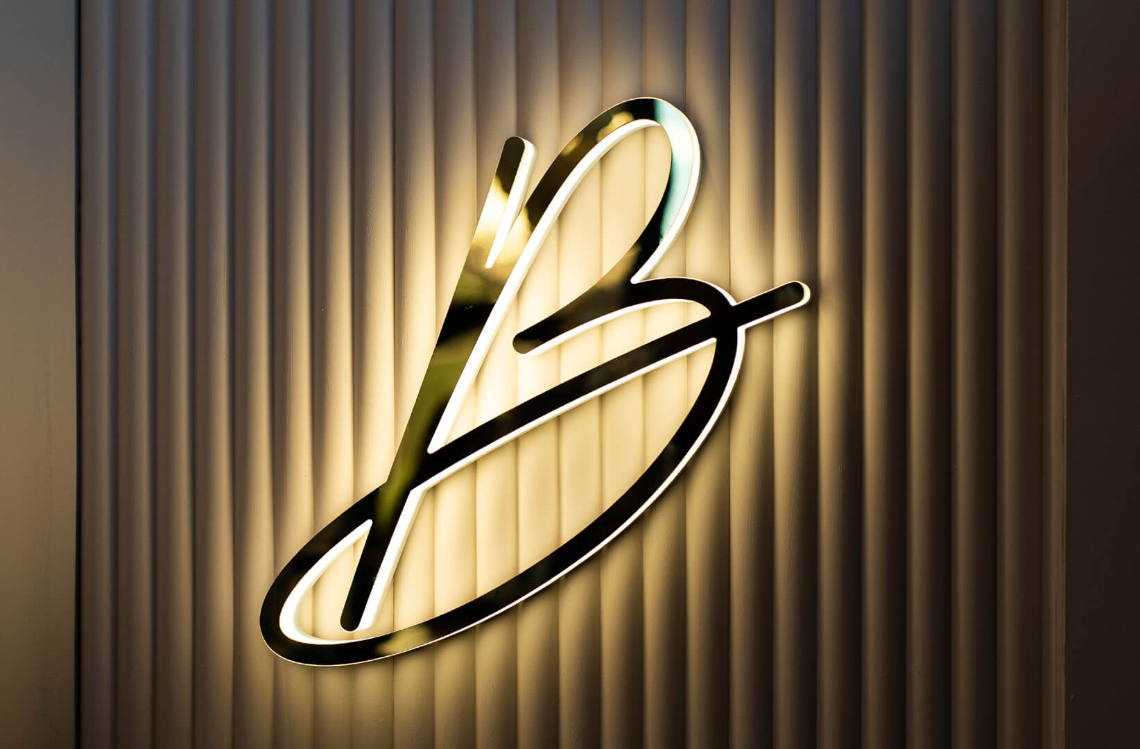 Letter B with Blushington logo in gold, glowing along the LED outline