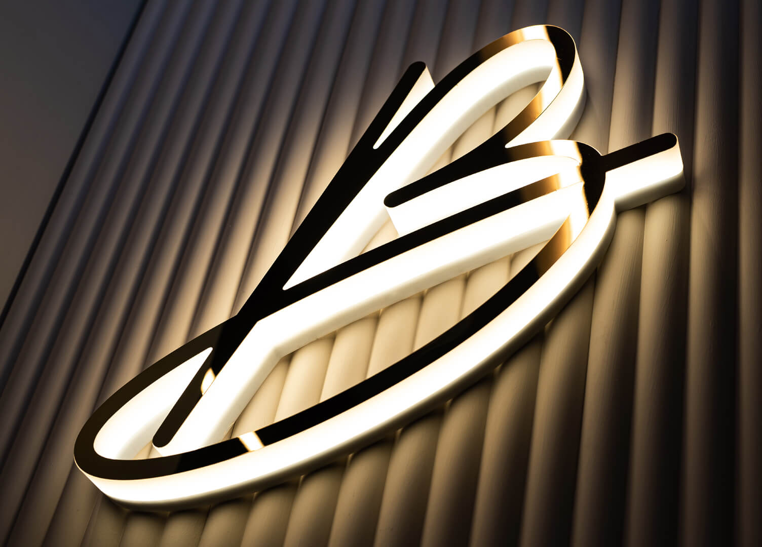 Letter B with Blushington logo in gold, glowing along the LED outline