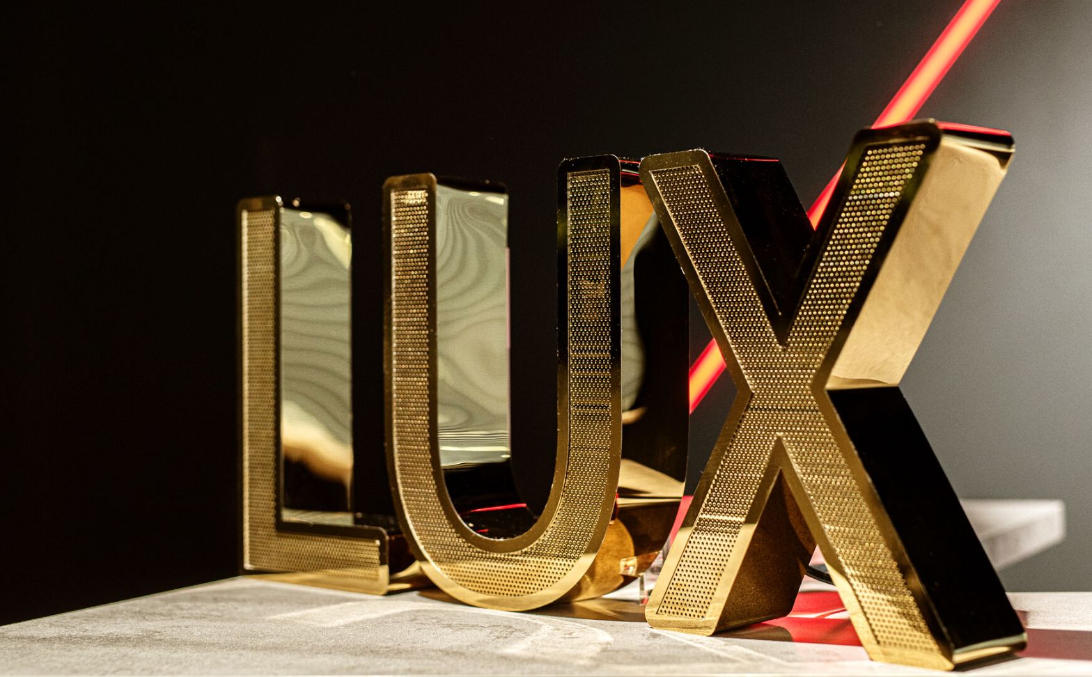 LUX letters in gold shiny perforated stainless steel in Mercedes showroom