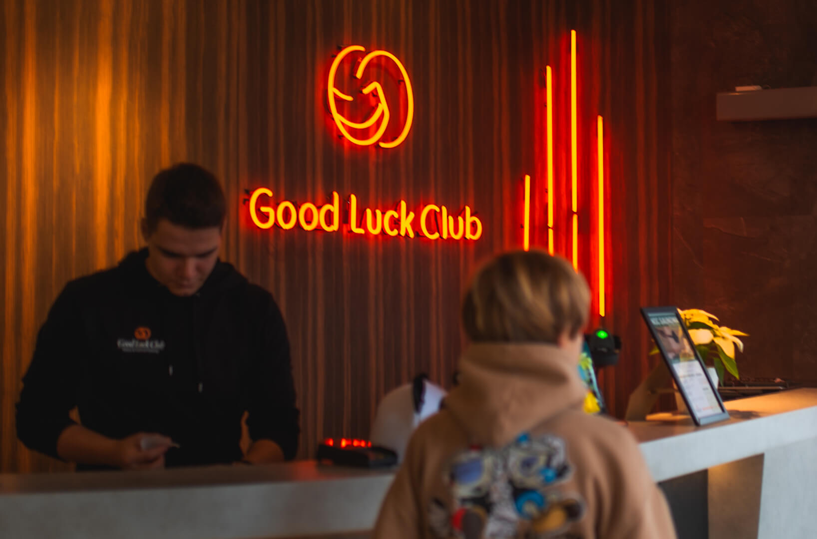 A red neon sign in the reception area along with the company logo.