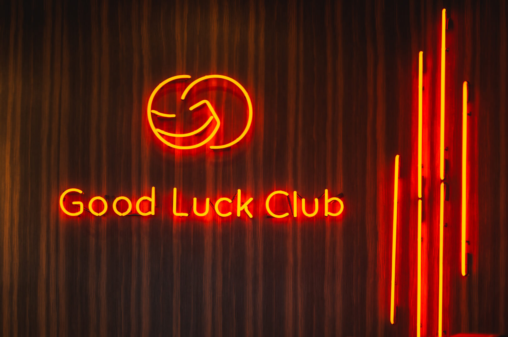 A red neon sign in the reception area along with the company logo.