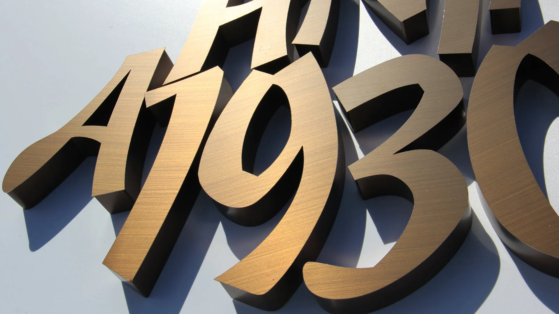 Numbers and letters made of stainless steel in brushed bronze.