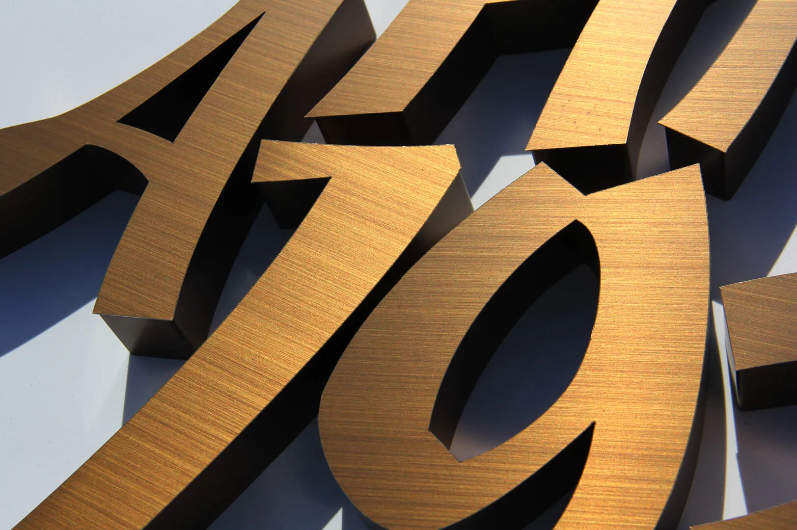 Numbers and letters made of stainless steel in brushed bronze.