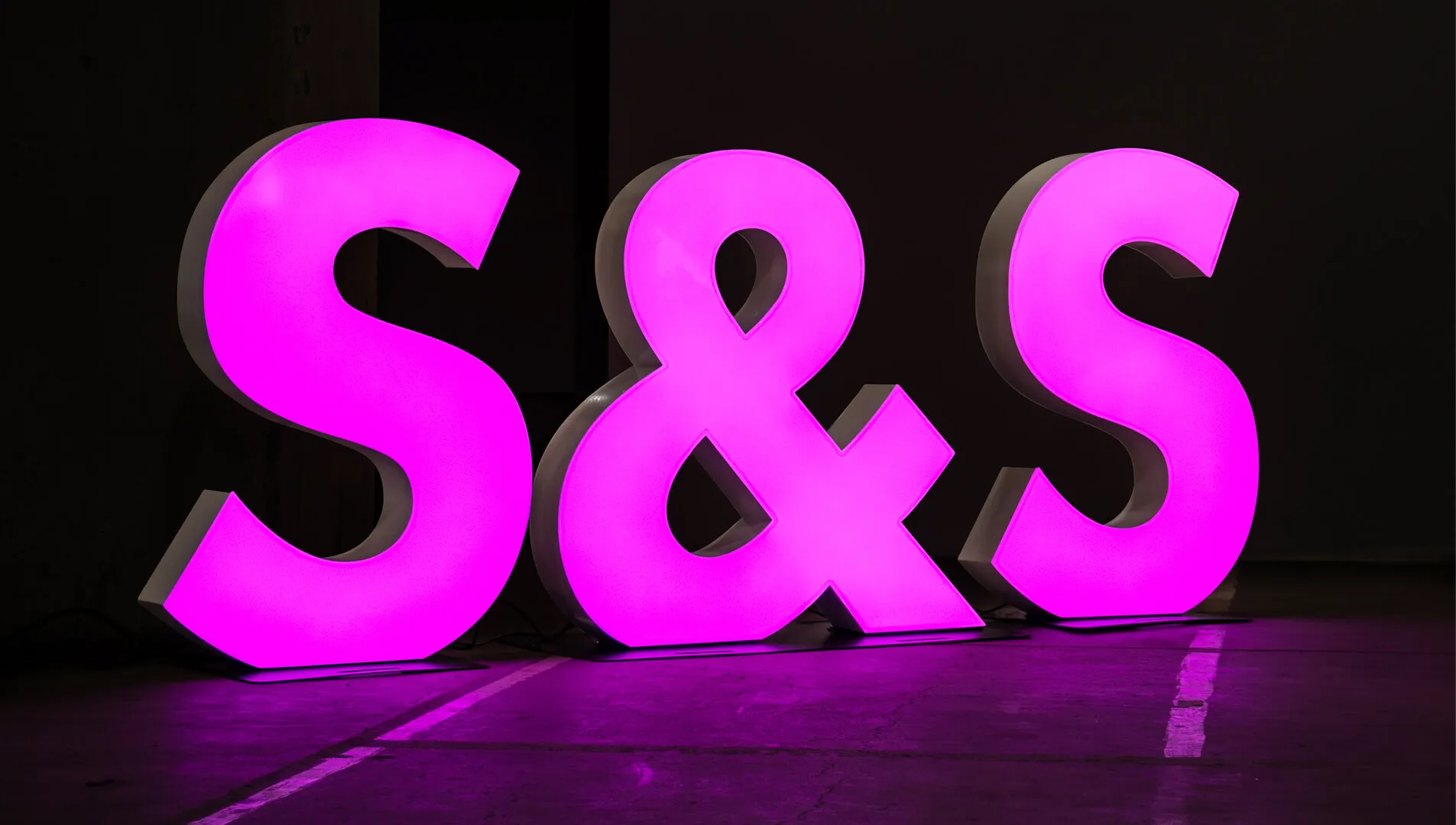 Large-format letters and symbol, purple in color