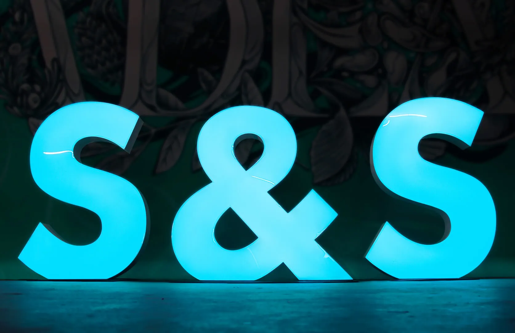 Large format letters and symbol, blue in color