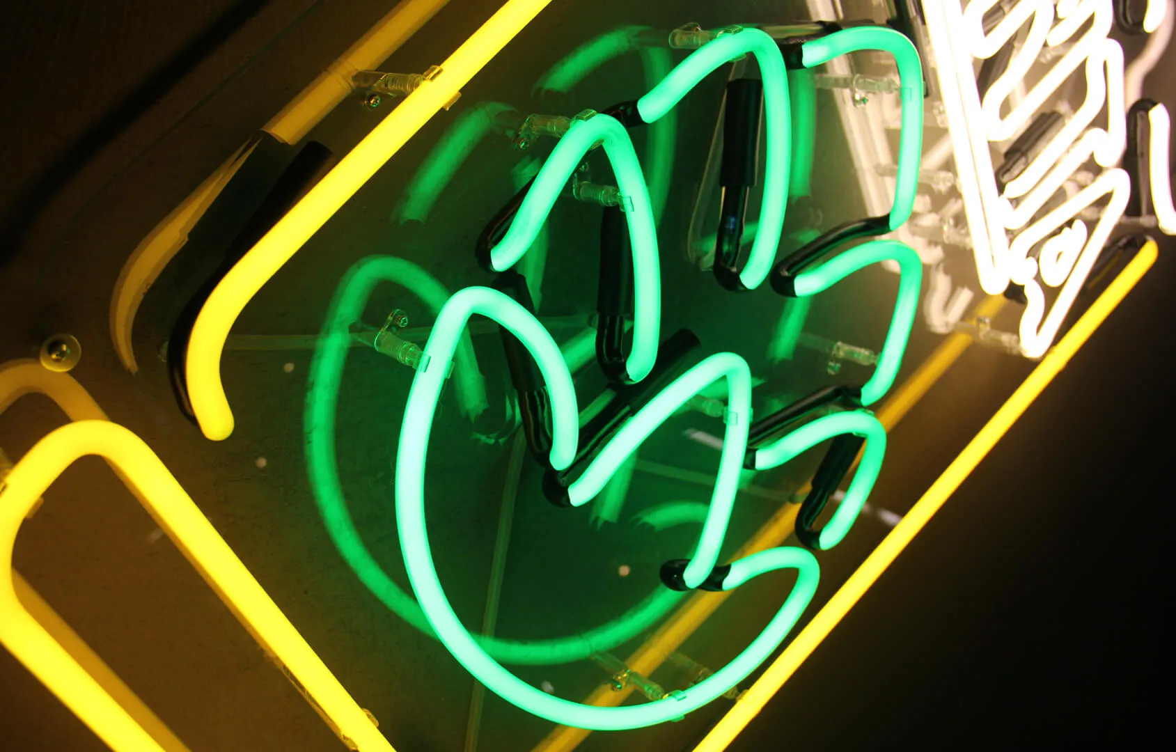 neon sign in the shape of a glass along with the inscription