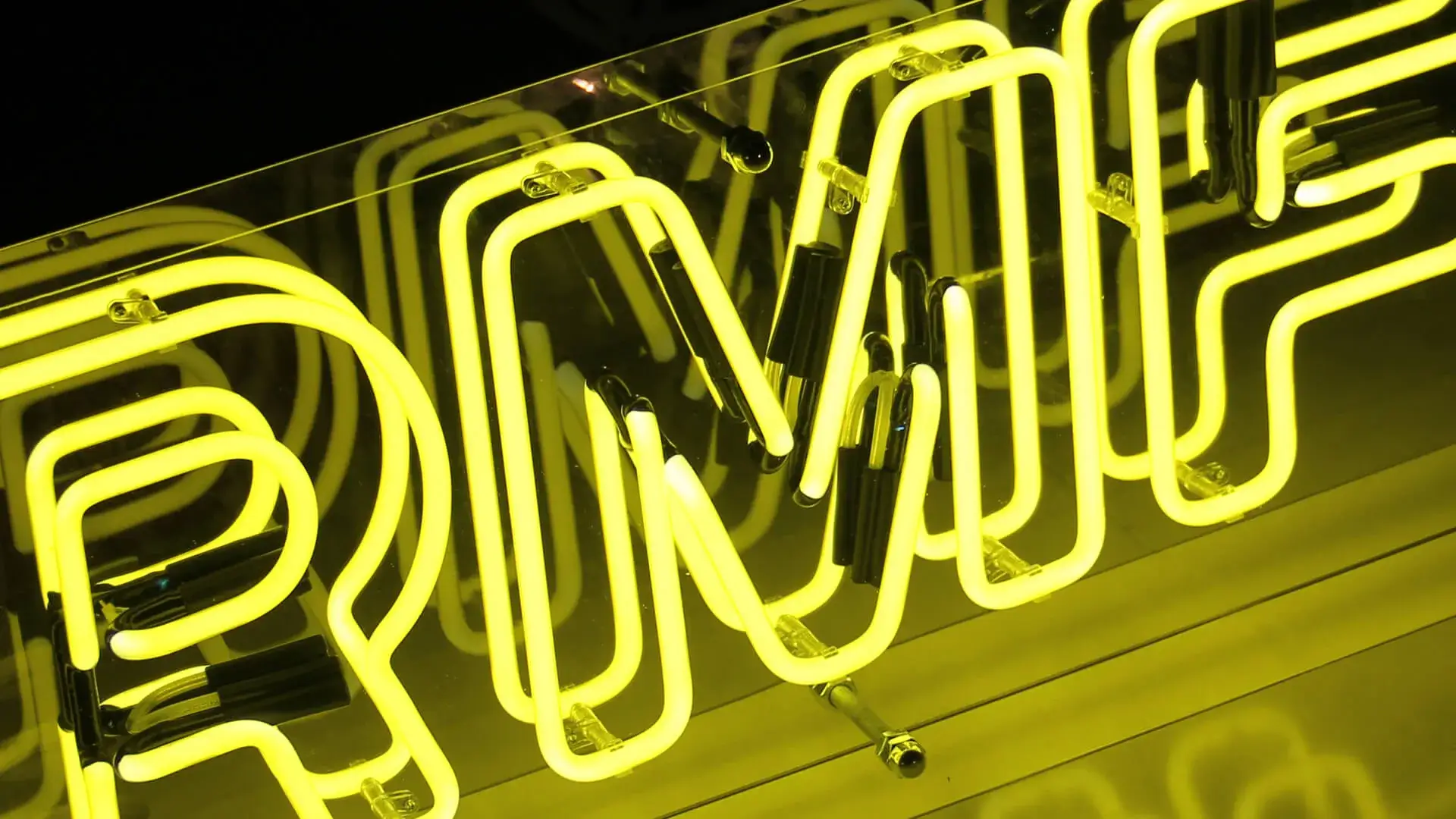 Yellow neon sign for RMF Radio, neon advertisement.