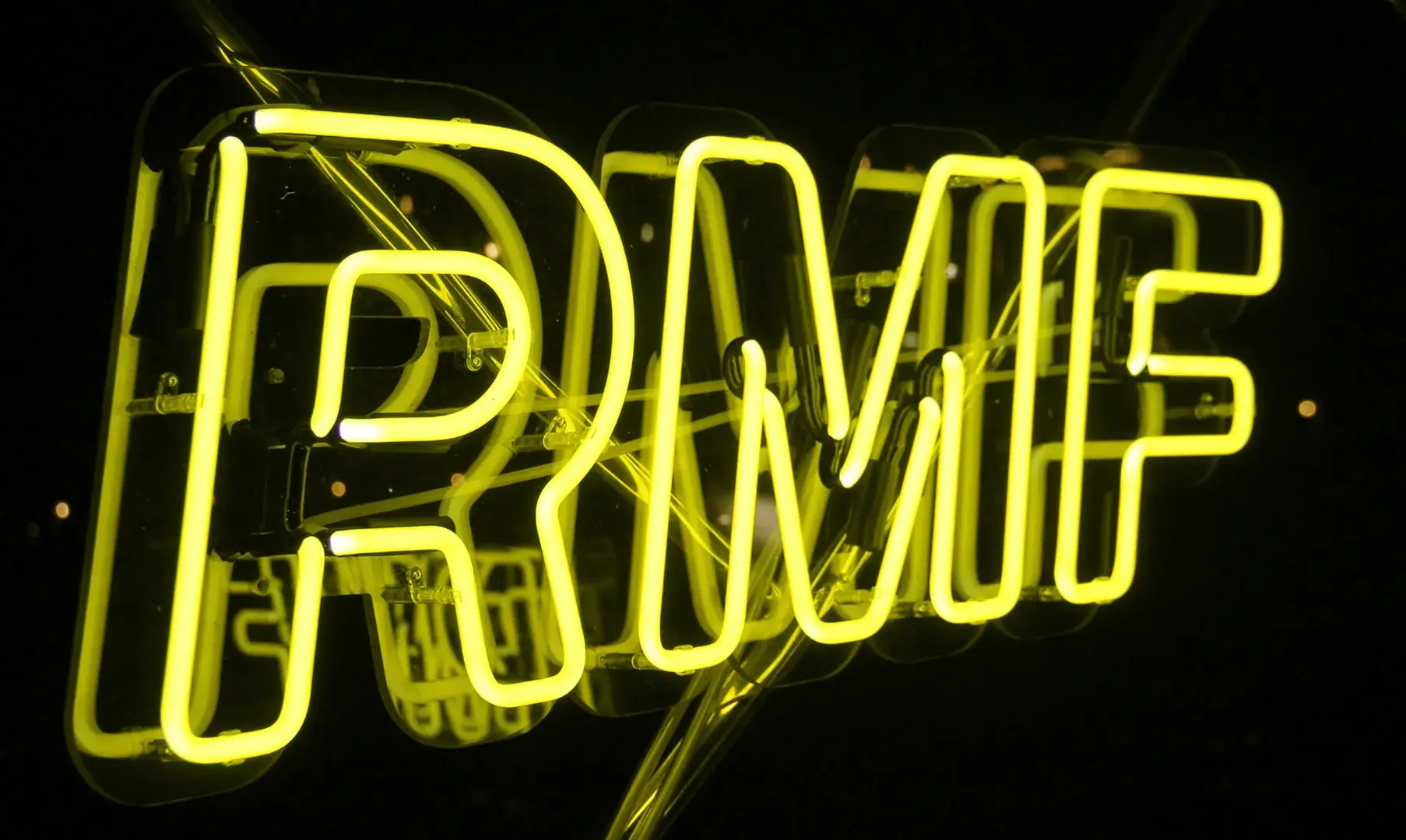 Yellow neon sign for RMF Radio, neon advertisement.