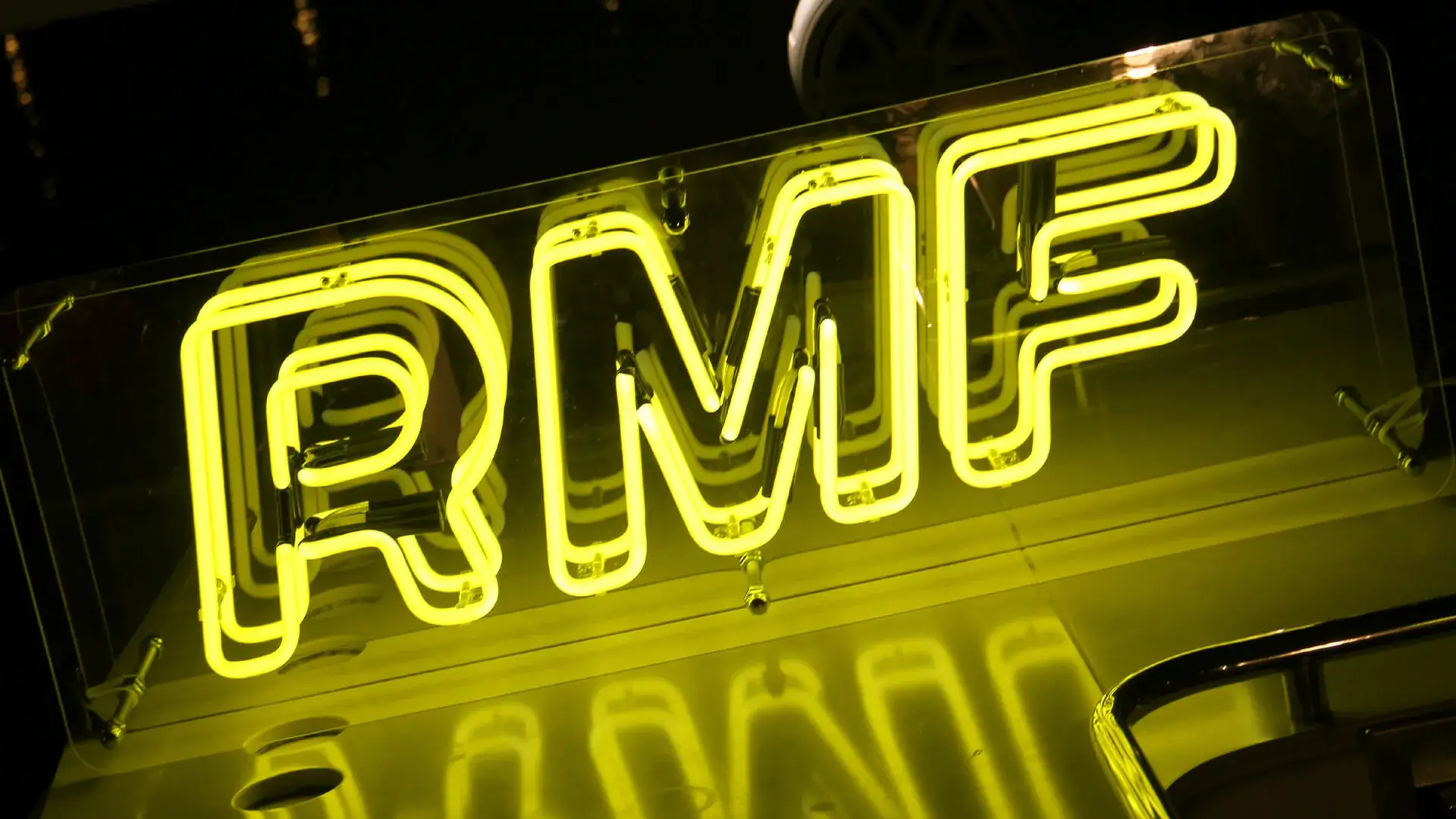 Yellow neon sign for RMF Radio, neon advertisement.