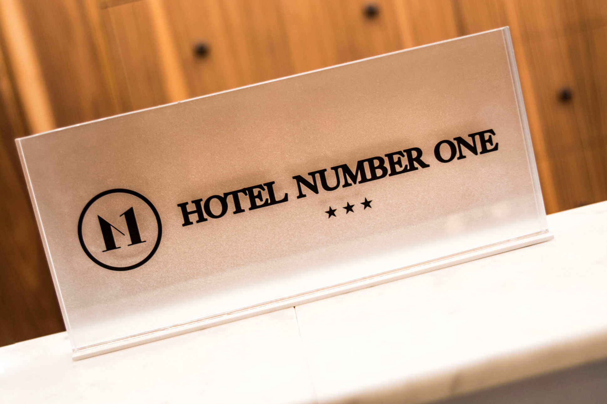 Hotel Number One - plaque presenting the name and logo of the hotel made of Plexiglas