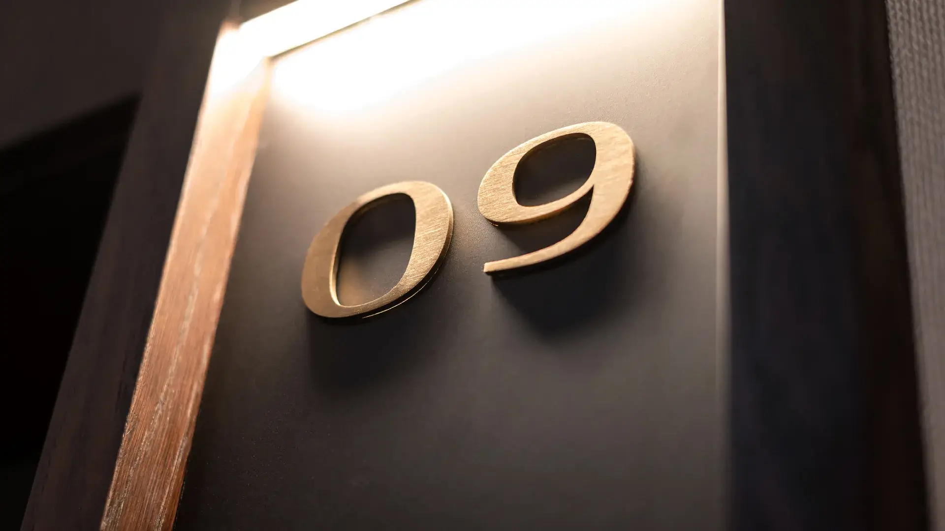 Numeral 9 made of polished gold plate, building signage.