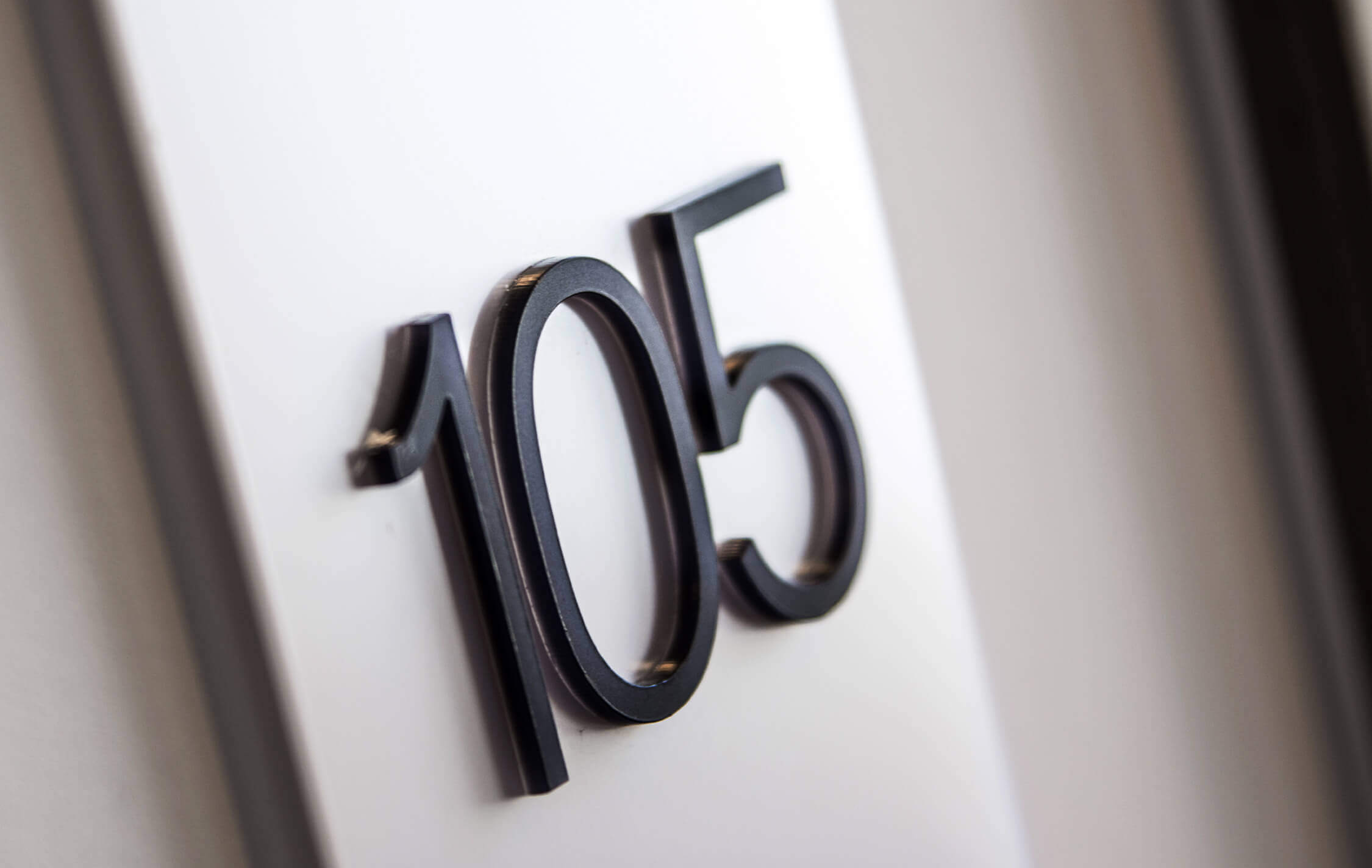 Hotel - signage of rooms with spatial letters next to the door