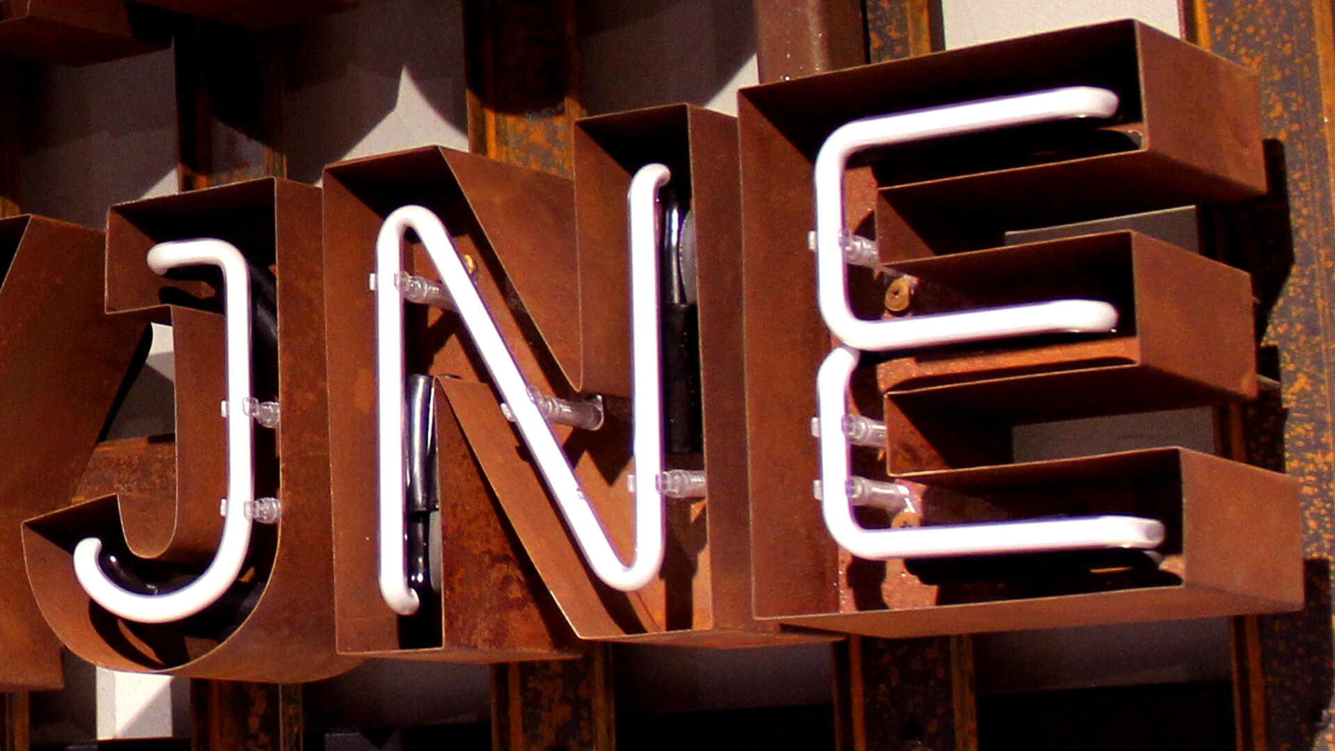 Rusted sheet metal letters with neon interior