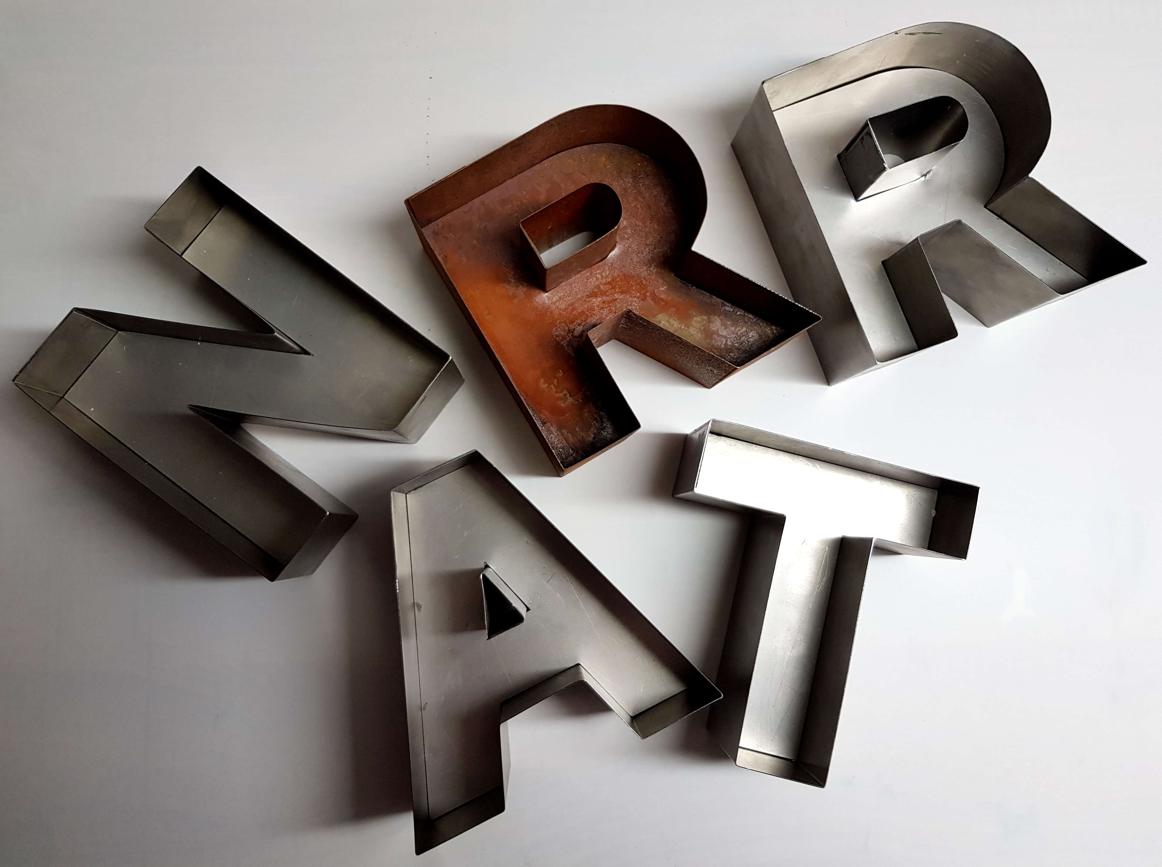 Rusty sheet metal and metal letters