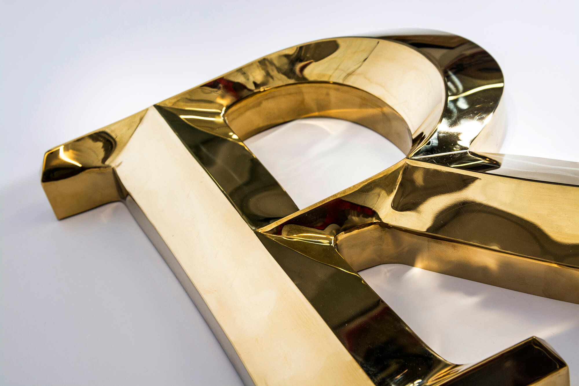 Gold prismatic letters made of metal