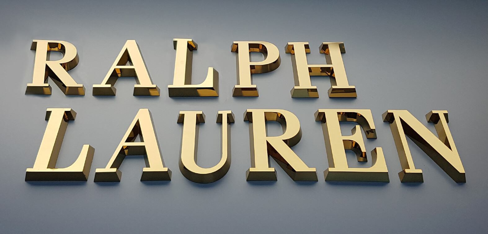 Ralph Lauren - gold spatial letters made of stainless steel sheeting