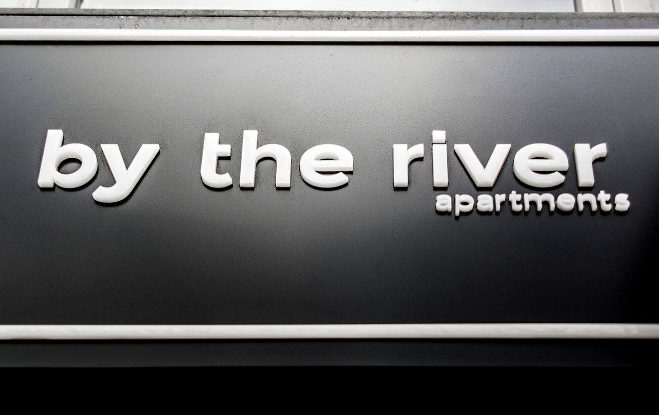 by the river - a company sign placed on an advertising coffer