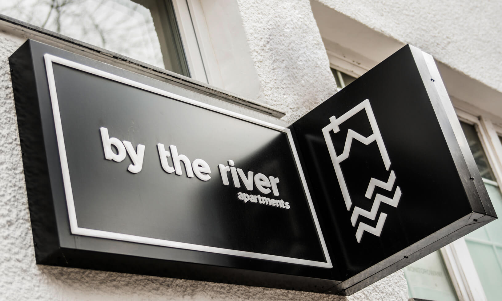 by the river - a company sign placed on an advertising coffer